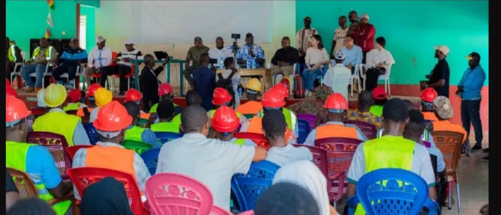 Session de formation en santé et sécurité au travail à Kolaboui : des jeunes en casques et gilets de sécurité face à la table des officiels